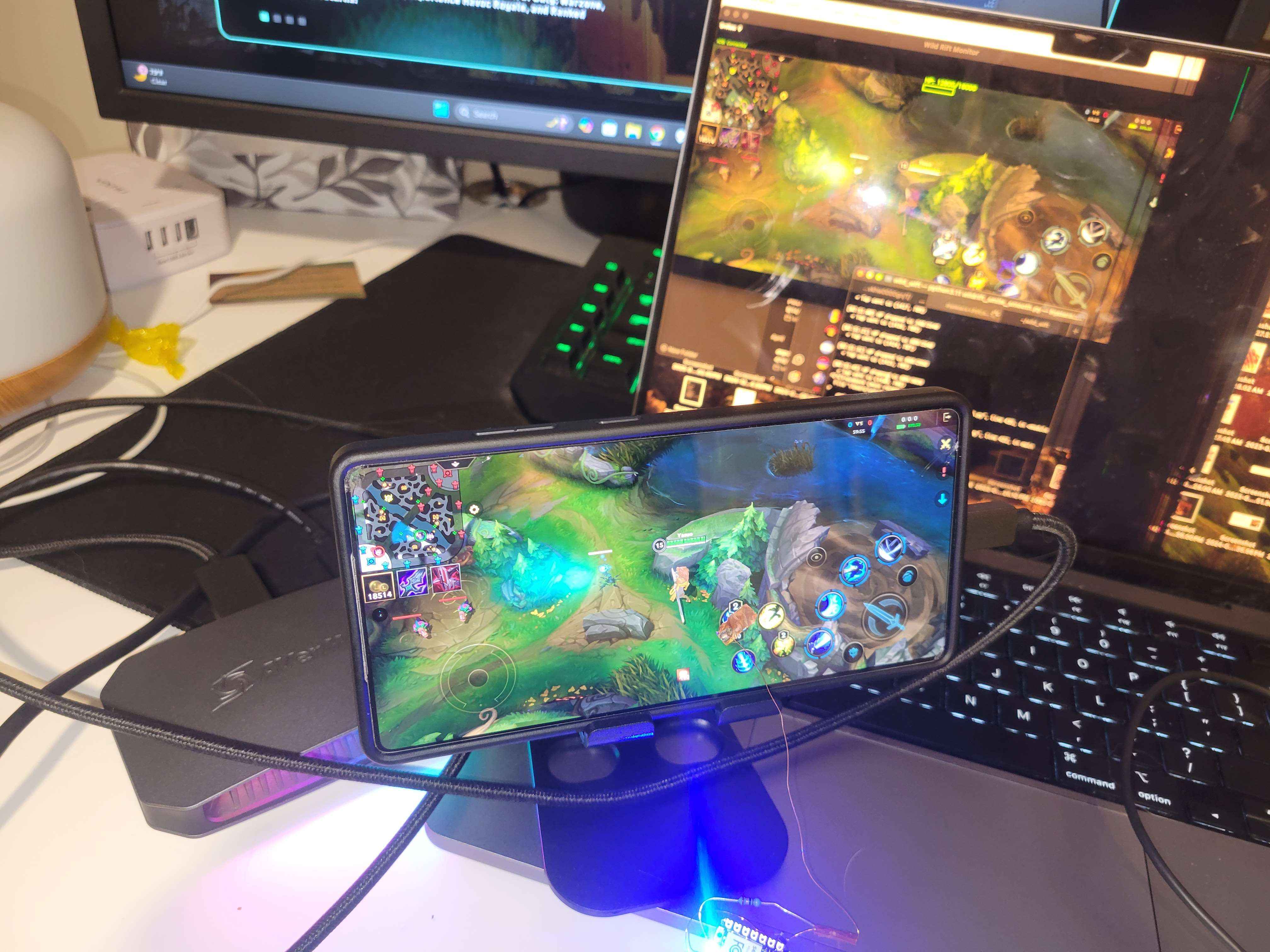 Phone running Wild Rift on a stand, connected to a laptop displaying a computer-vision monitor of the game screen.